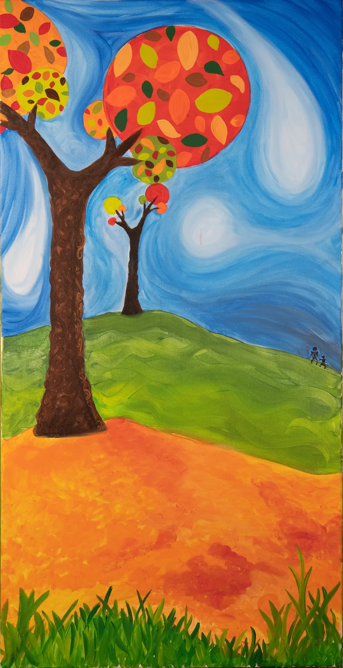 A bright autumn tree beneath a swirling blue sky
