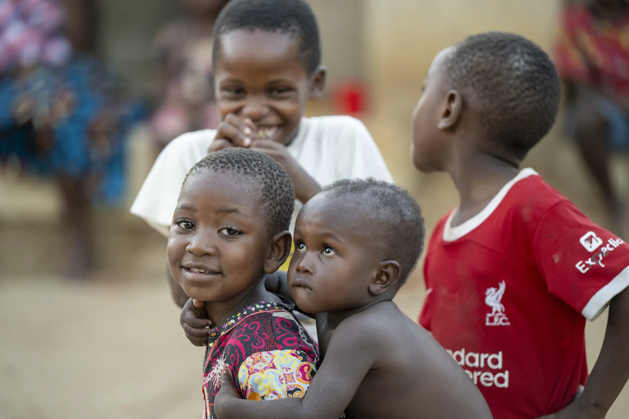 A group of children laughing and embracing in Malawi