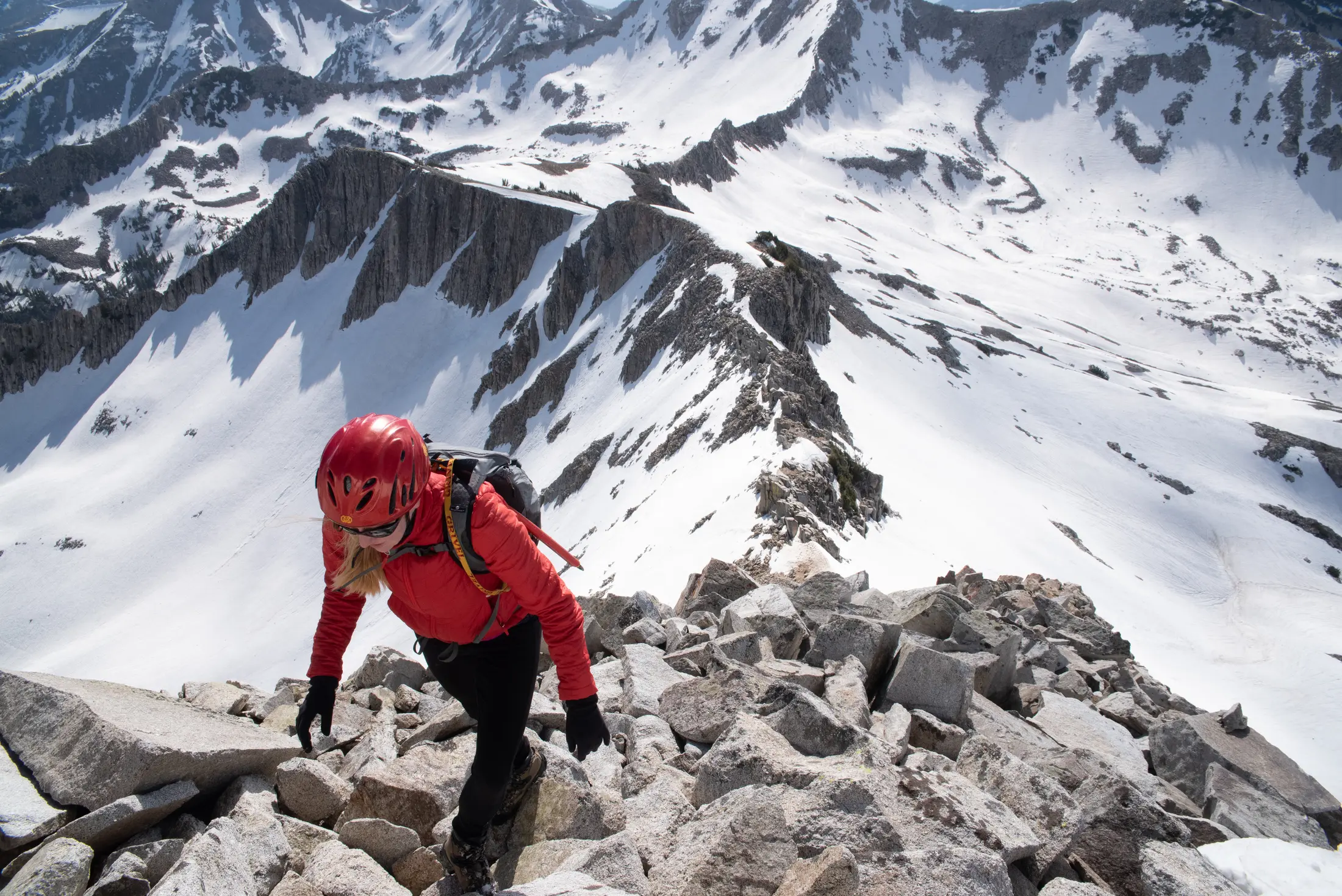 Rachel Engle climbing a rocky alpine ridge on the Pfeifferhorn